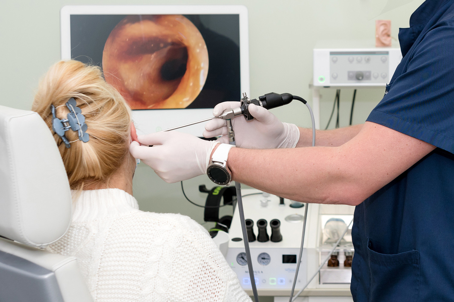 Patient's ear is being checked by an Ear, Nose and Throat doctor